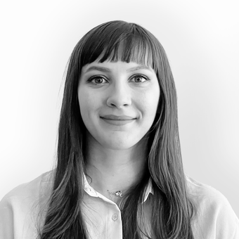 A black and white photo of a woman with long hair and bangs.