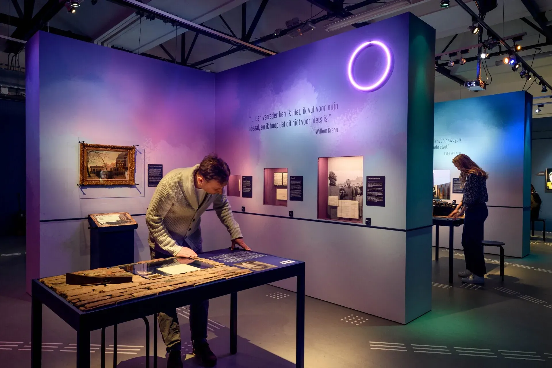 A man is working on a table in a museum.