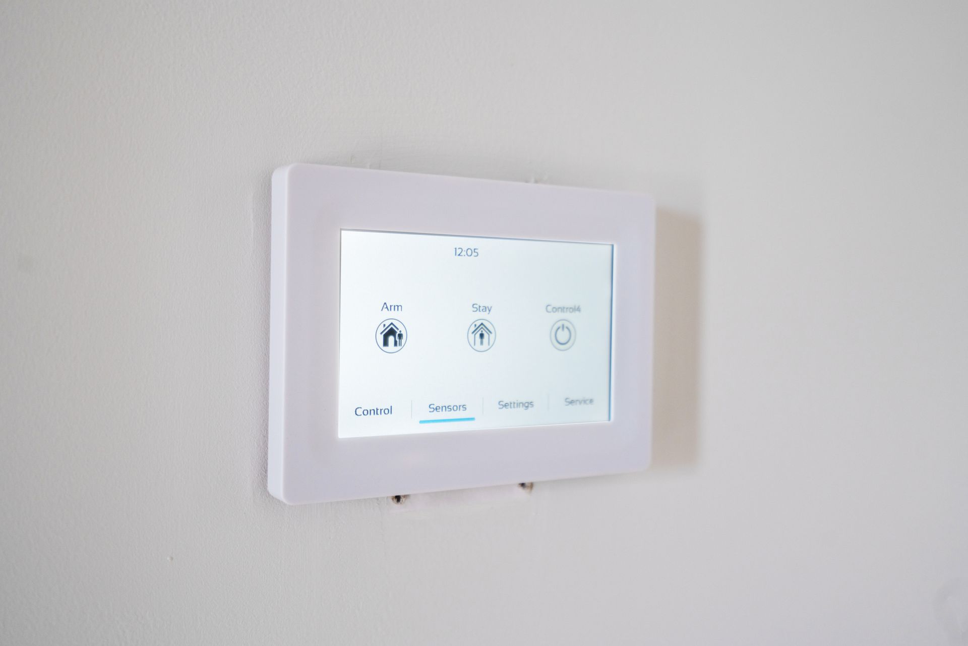 White wall-mounted touchscreen with icons: Home, Lock, Schedule, and control buttons.