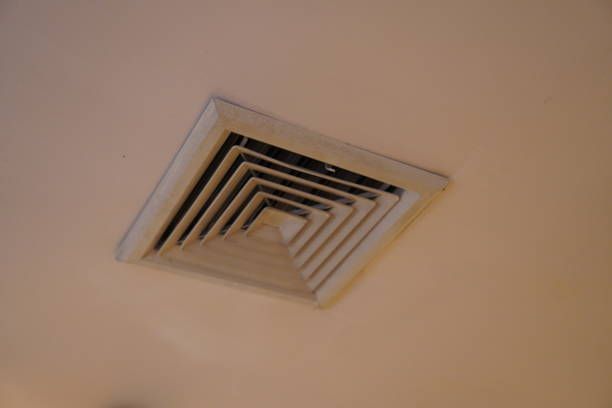 Ceiling air vent with square, layered design; white and gray colors.