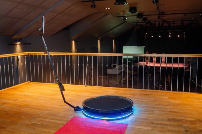 A round object is sitting on a wooden floor in a room.