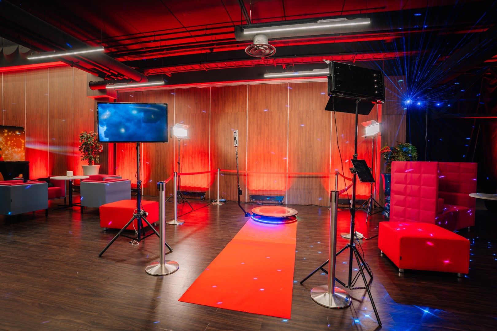 There is a red carpet  and 360 photo booth in the middle of the room