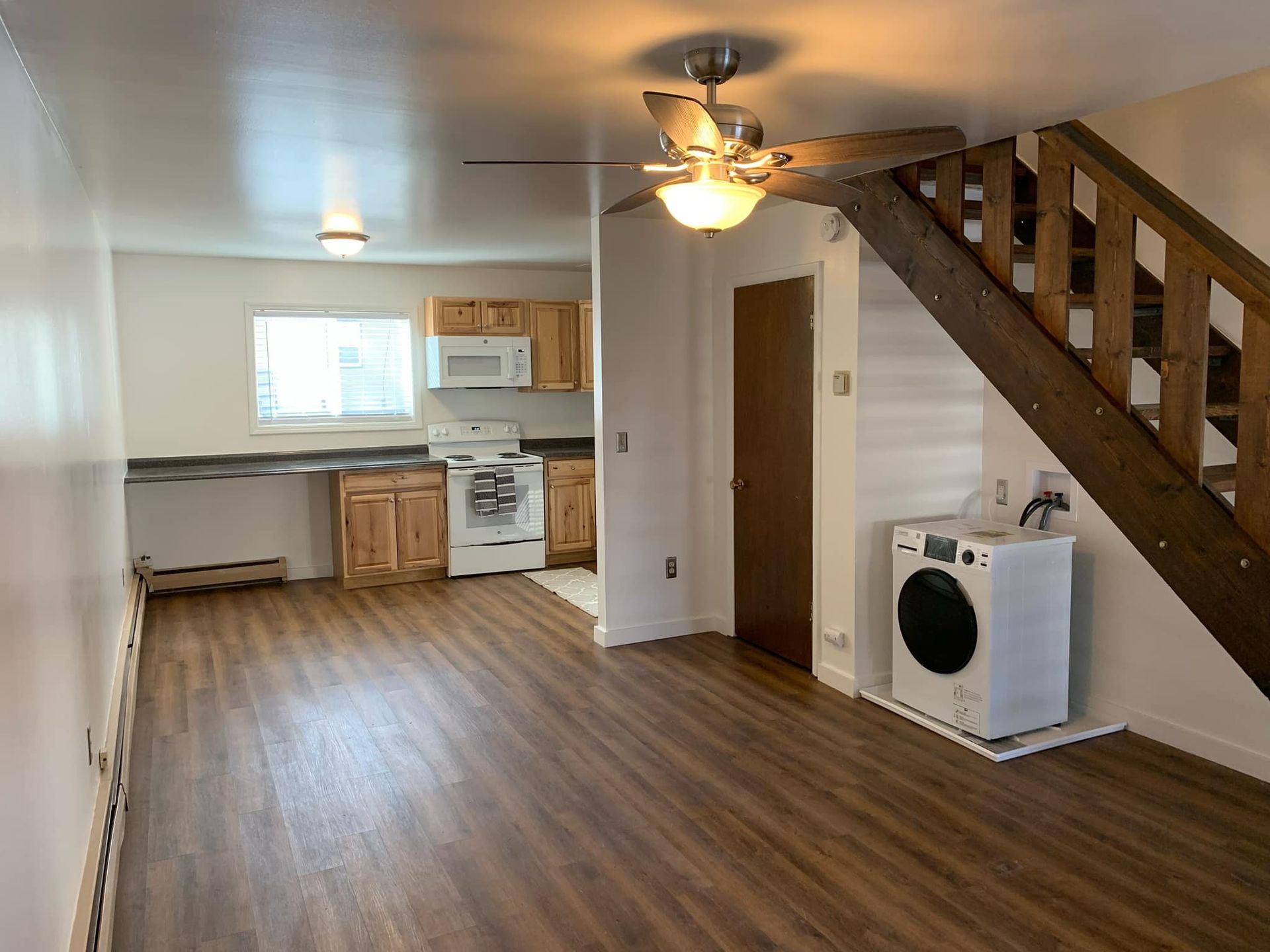 There is a washer and dryer in the middle of the room.