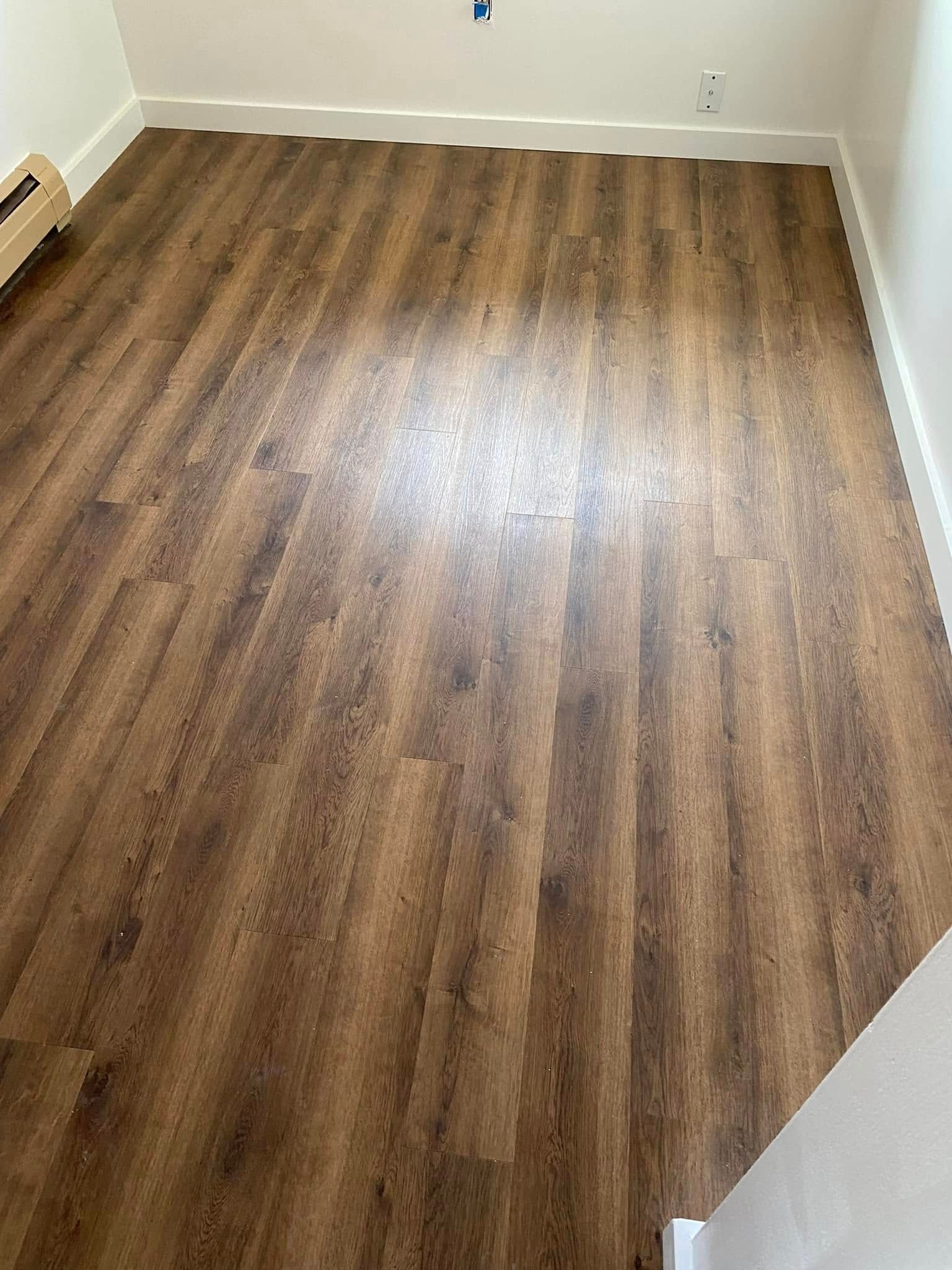 A room with a wooden floor and white walls.