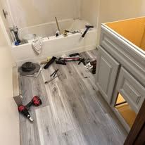 A bathroom with a bathtub and a sink being remodeled.