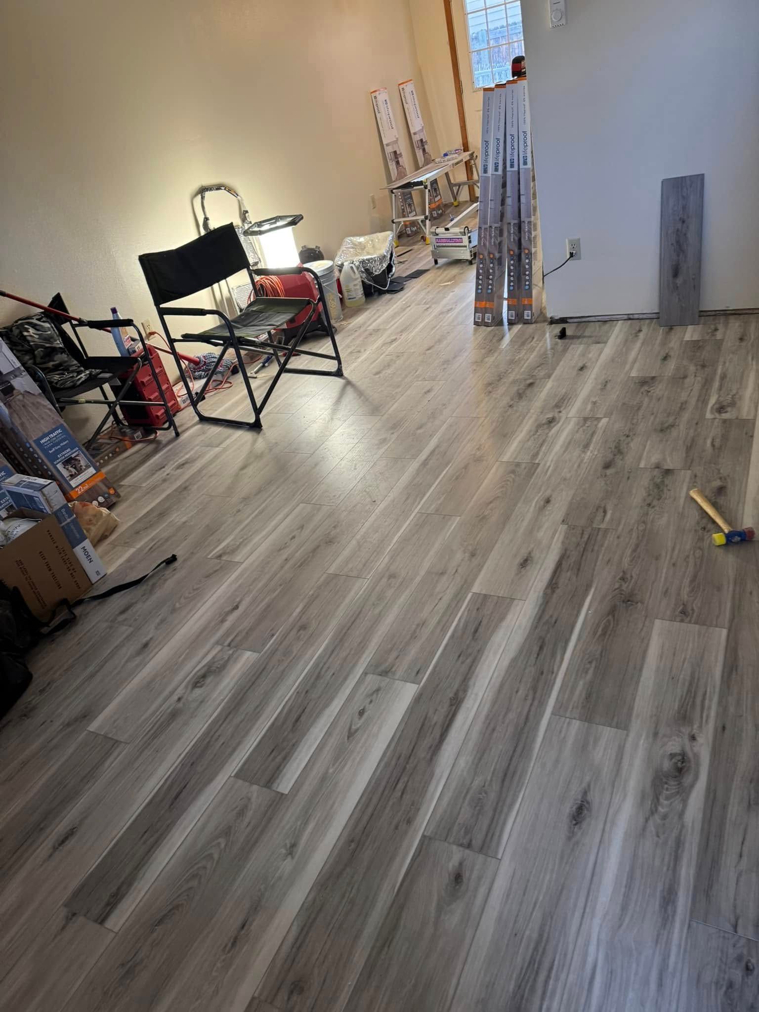 A room with a wooden floor and a chair in it.