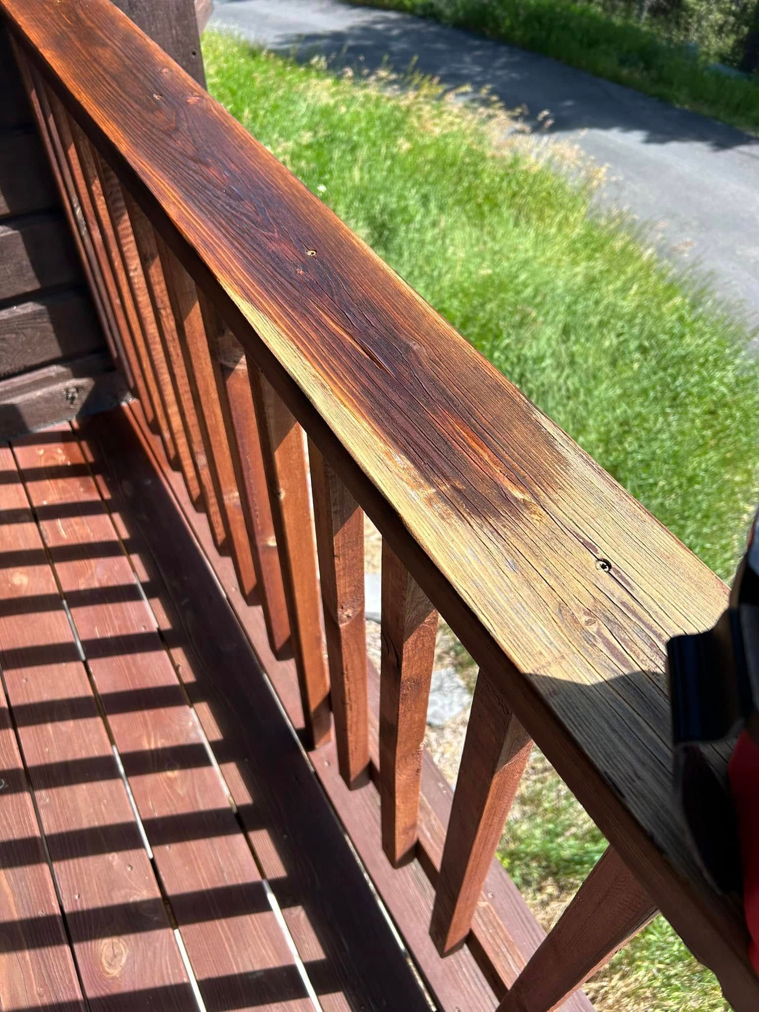 A close up of a wooden railing on a deck.
