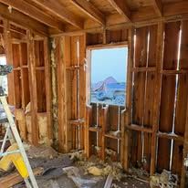 A room with a ladder and a window in it.