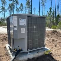 Gray air conditioning unit, Puron brand, on a concrete pad outdoors.