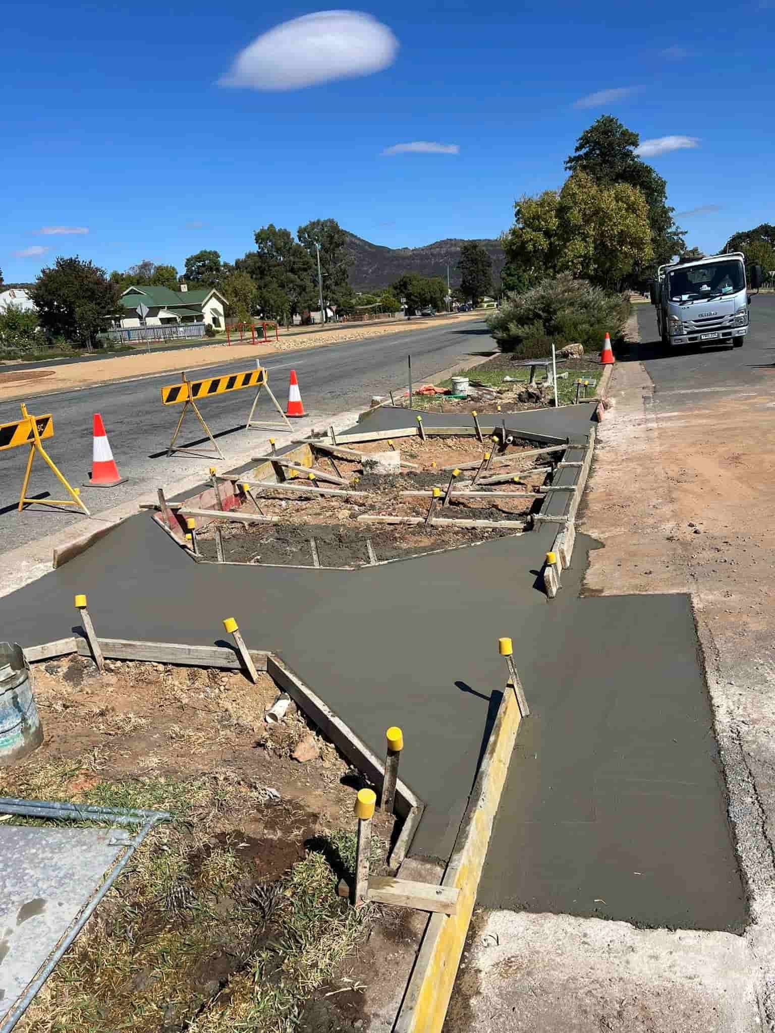A Concrete Walkway is Being Built on the Side of a Road — Brycey's Concreting In Frederickton, NSW
