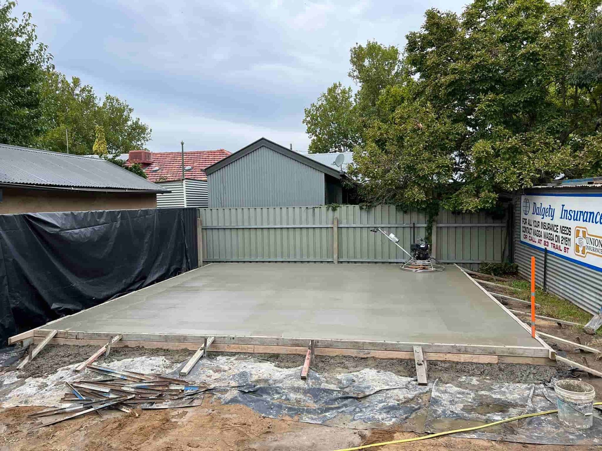 A Concrete Driveway is Being Built in Front of a House — Brycey's Concreting In Frederickton, NSW