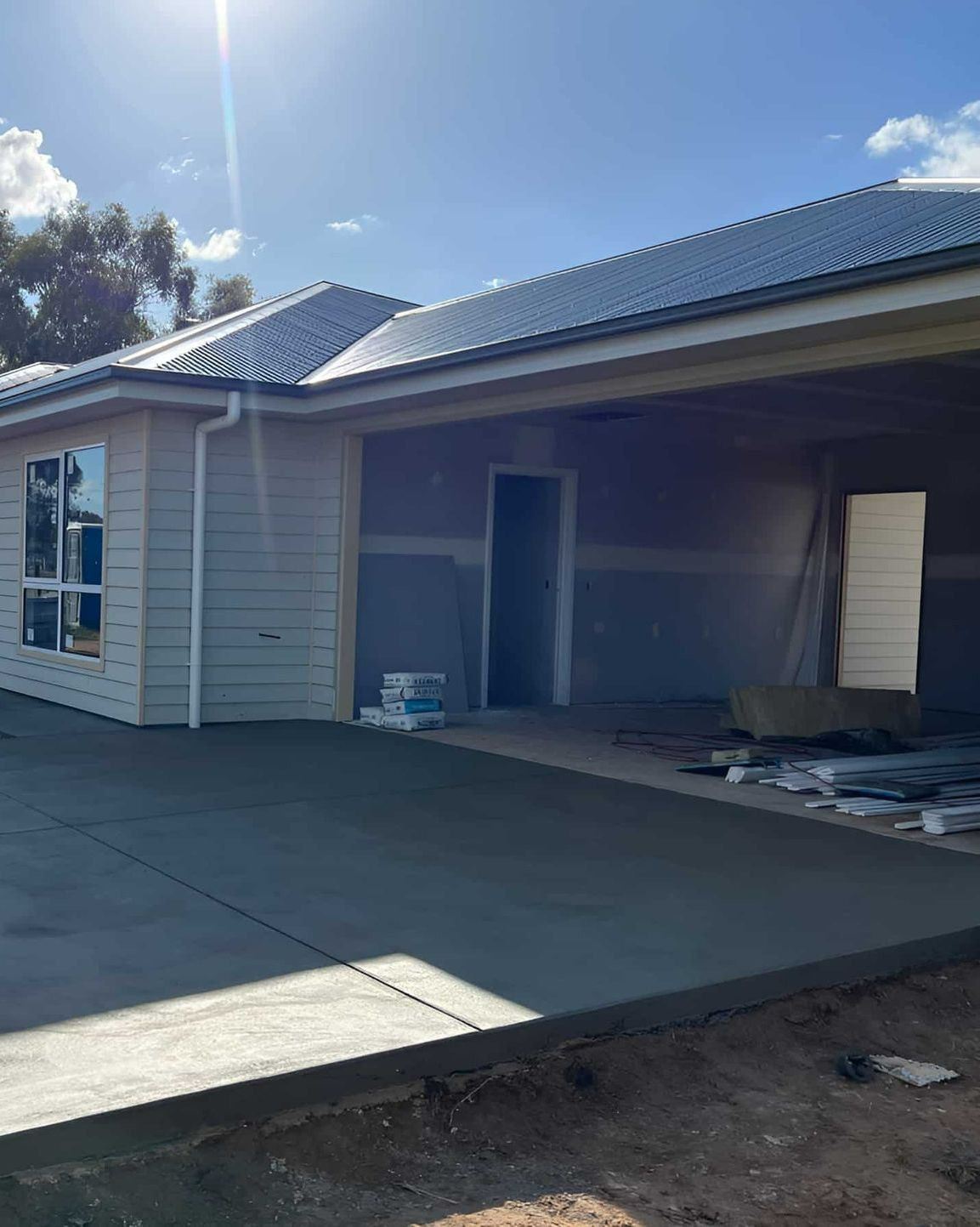 A House Under Construction With a Concrete Driveway — Brycey's Concreting In Frederickton, NSW