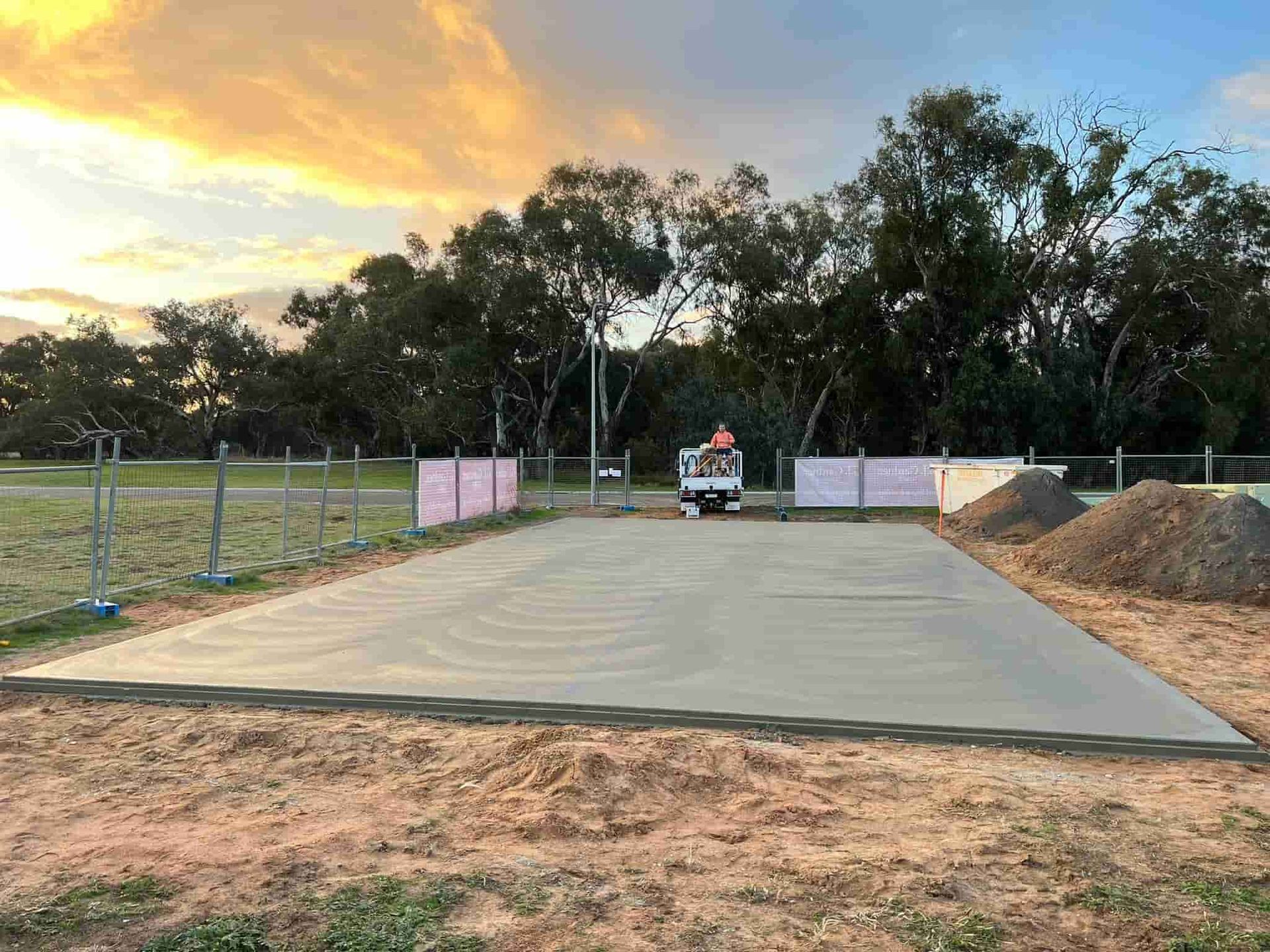 A Large Concrete Slab is Sitting in the Middle of a Dirt Field — Brycey's Concreting In Frederickton, NSW