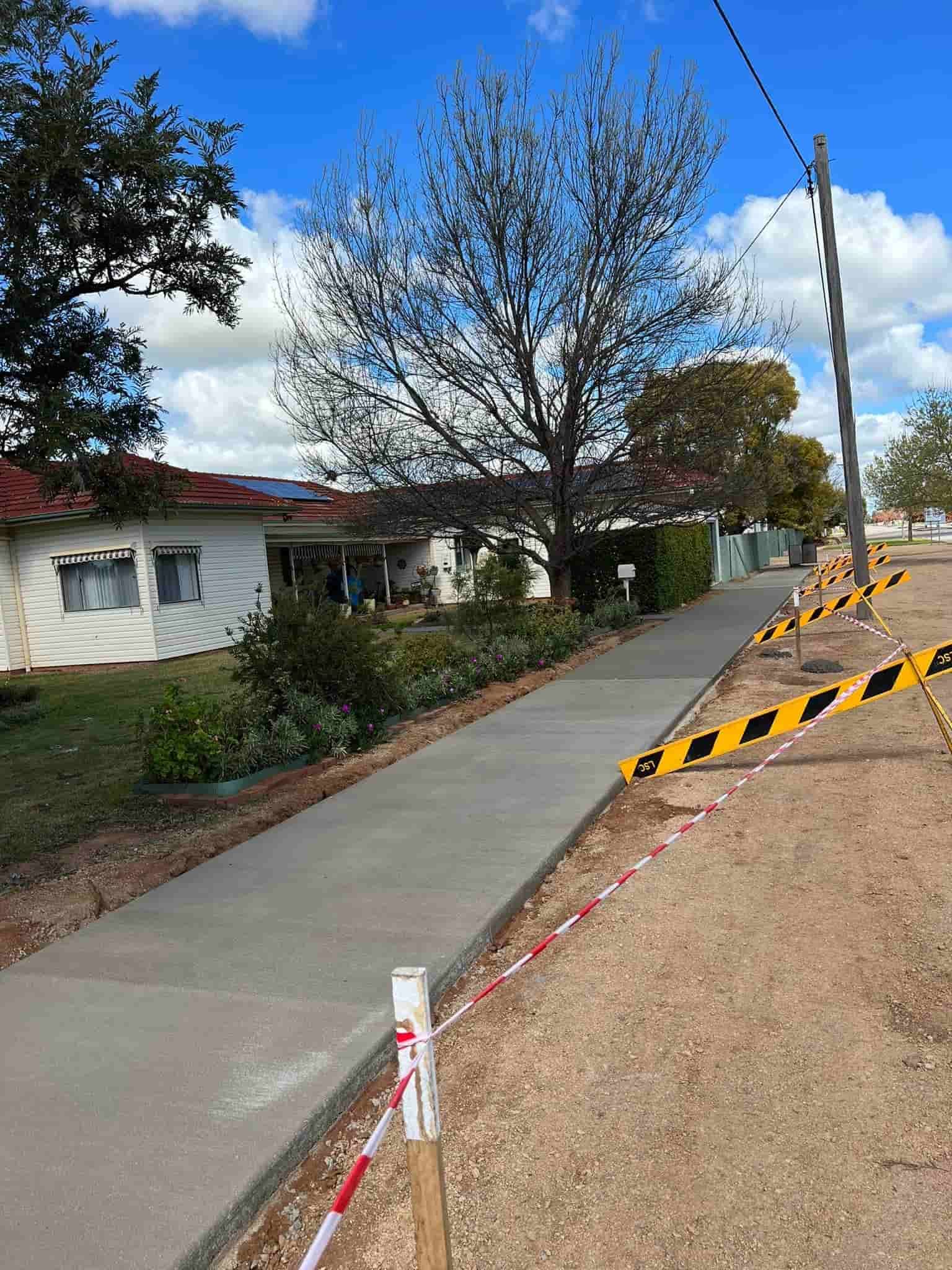 A Concrete Walkway is Being Built in Front of a House — Brycey's Concreting In Frederickton, NSW