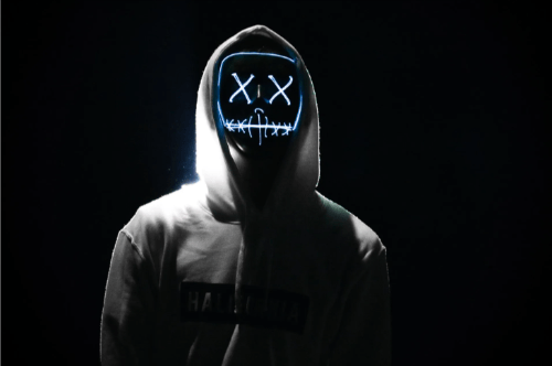 A person in a black NDM cap with two glowing 