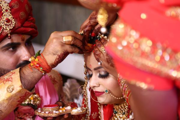 Traditional Hindu wedding attire on a man & woman marrying