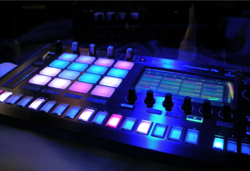 A mixer in a dark room with the knobs colorfully lit up