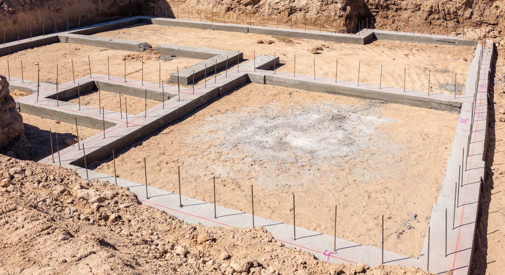 “Prepared foundation base with compacted soil and layout lines before block wall construction during a block and retaining wall service in Santa Ana, CA”