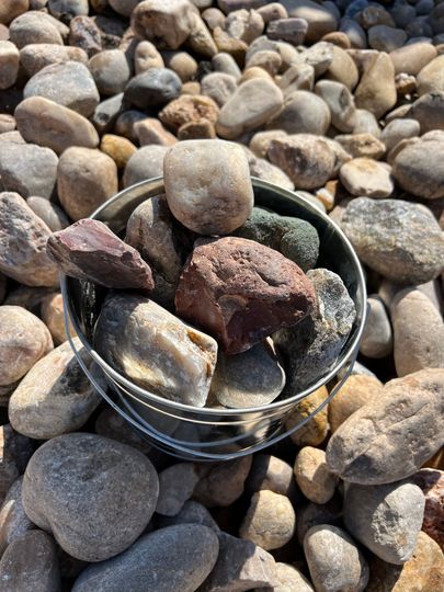 A pile of rocks sitting on top of a gravel road.