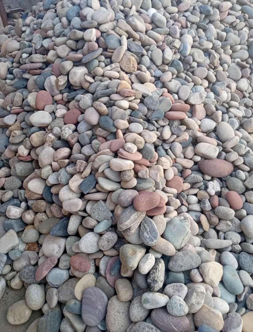 A pile of rocks is sitting on the ground.