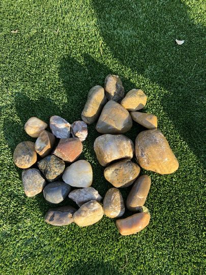 A pile of rocks sitting on top of each other on the ground.