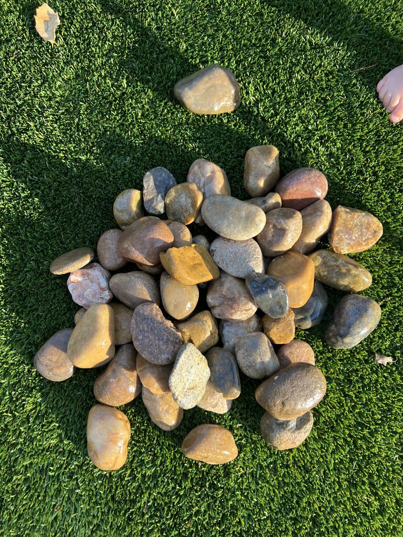 A pile of rocks is sitting on top of a fence.