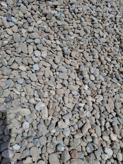 A pile of rocks is sitting on the ground.