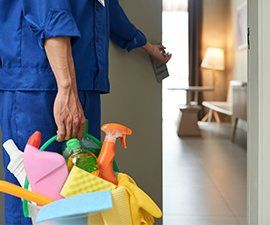 Commercial Cleaning — Entering a Room Carrying Cleaning Products in Jacksonville, FL