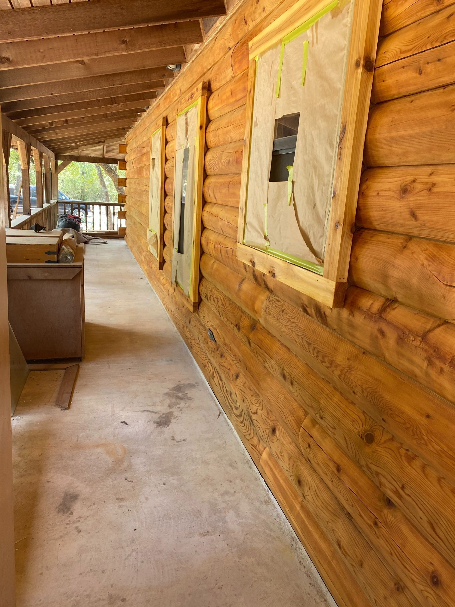 A long hallway with wooden walls and a concrete floor