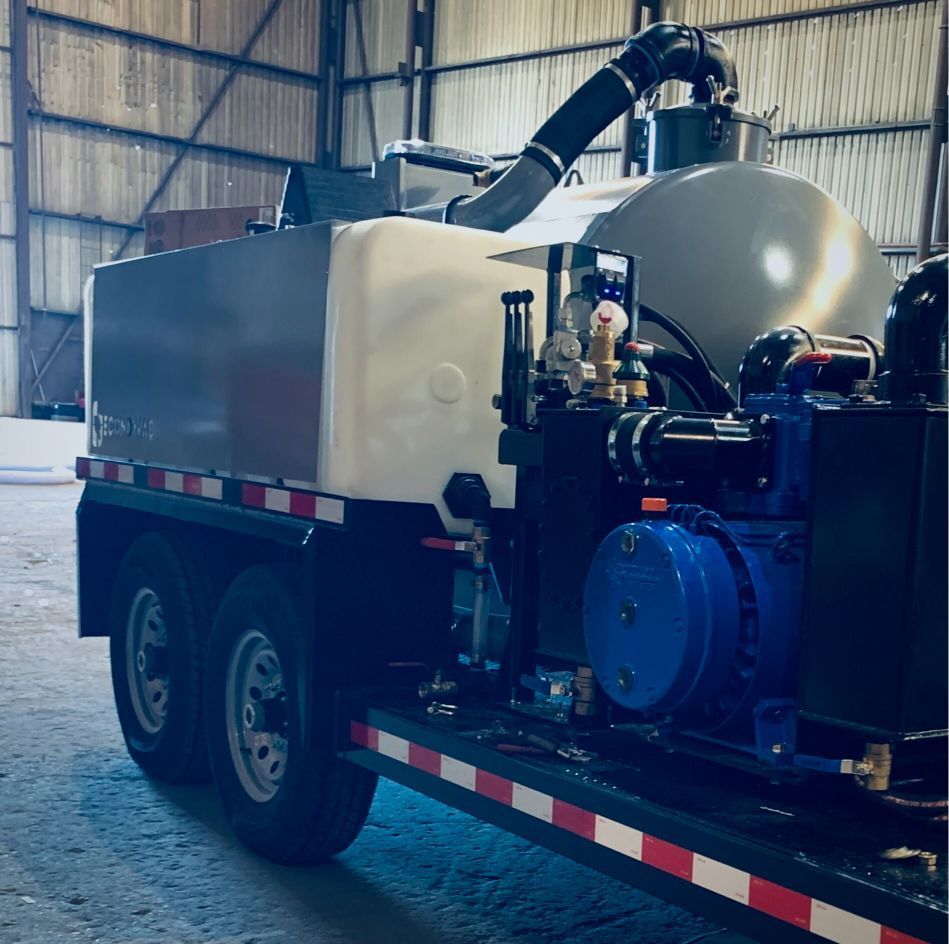 A large tanker truck is parked in a warehouse