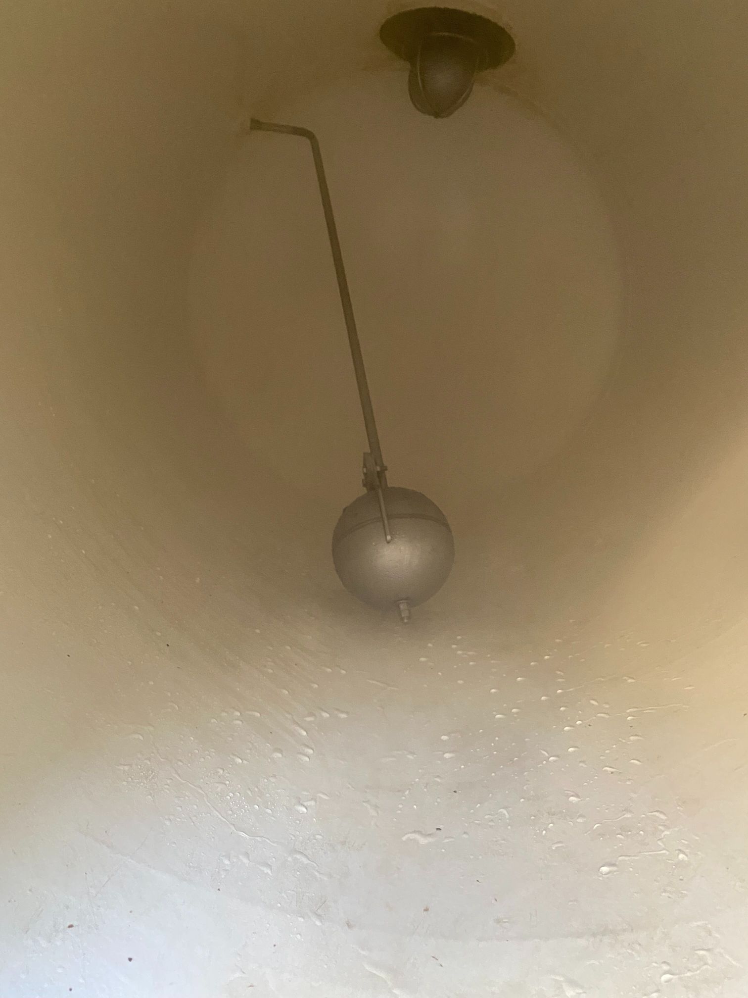 A close up of a water meter in a white tank.