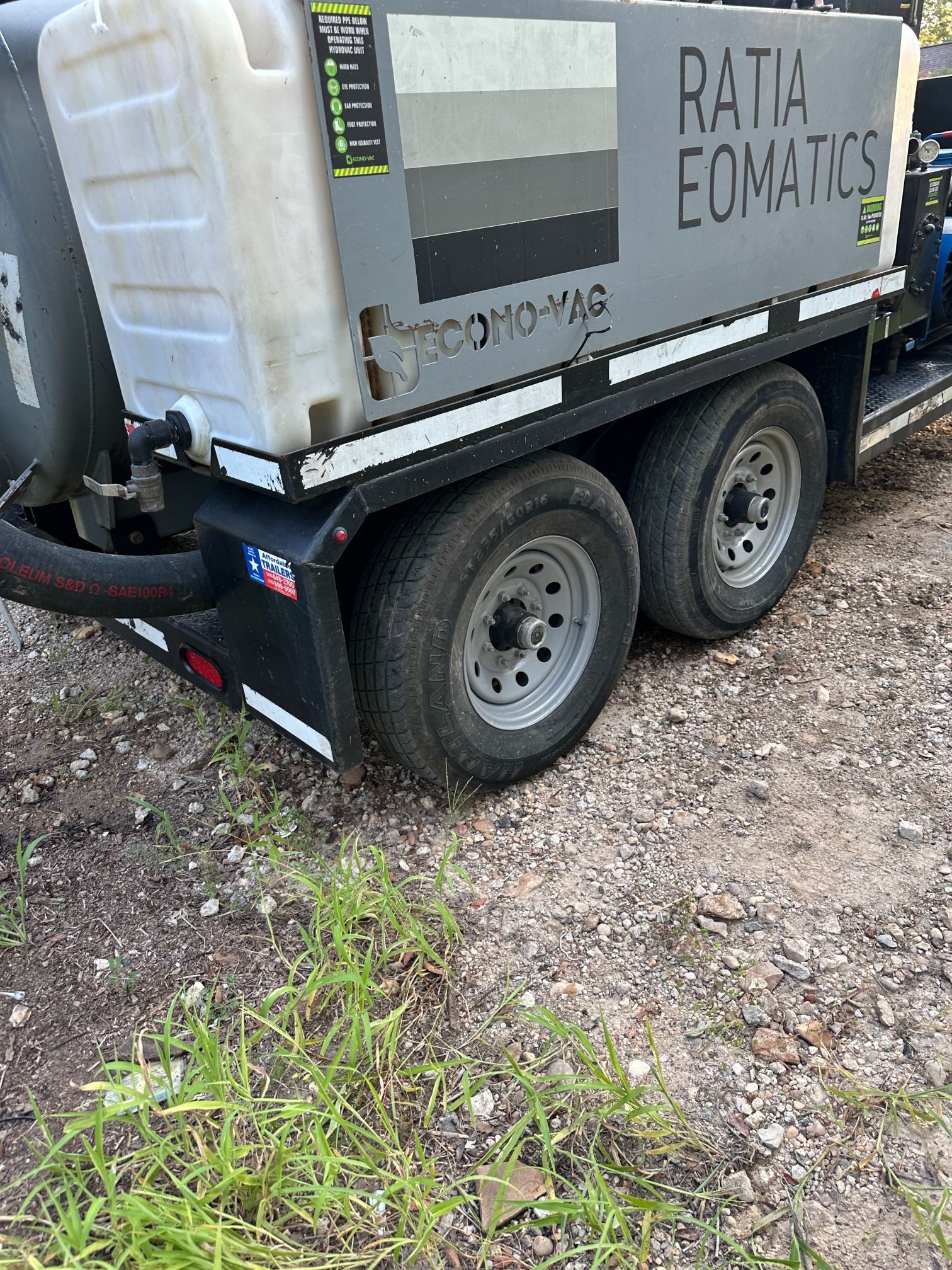 A vacuum truck is parked on the side of the road.