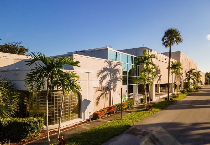 A large building with palm trees in front of it