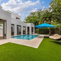 backyard with pool and artificial grass turf