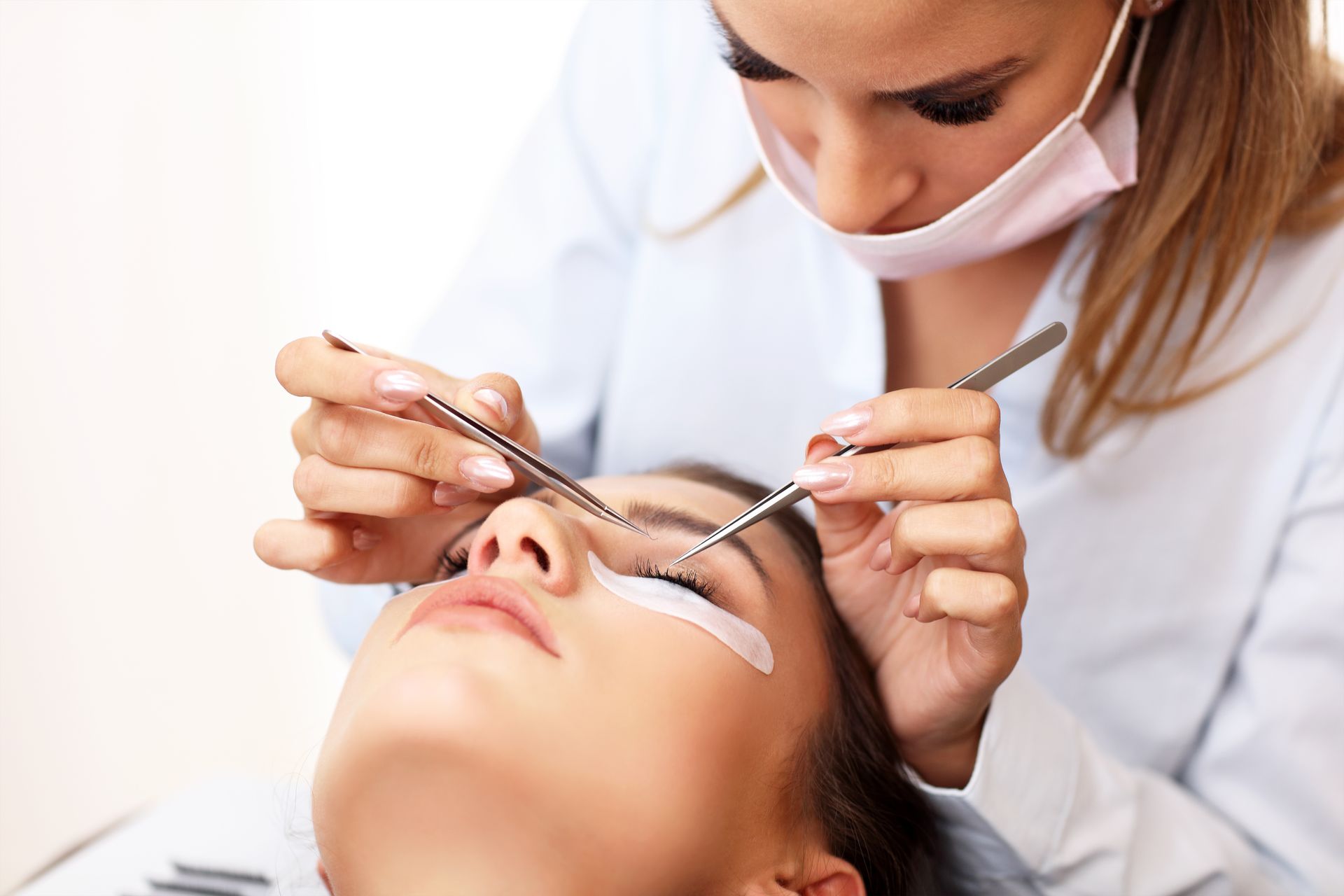 a woman getting eyelash extensions