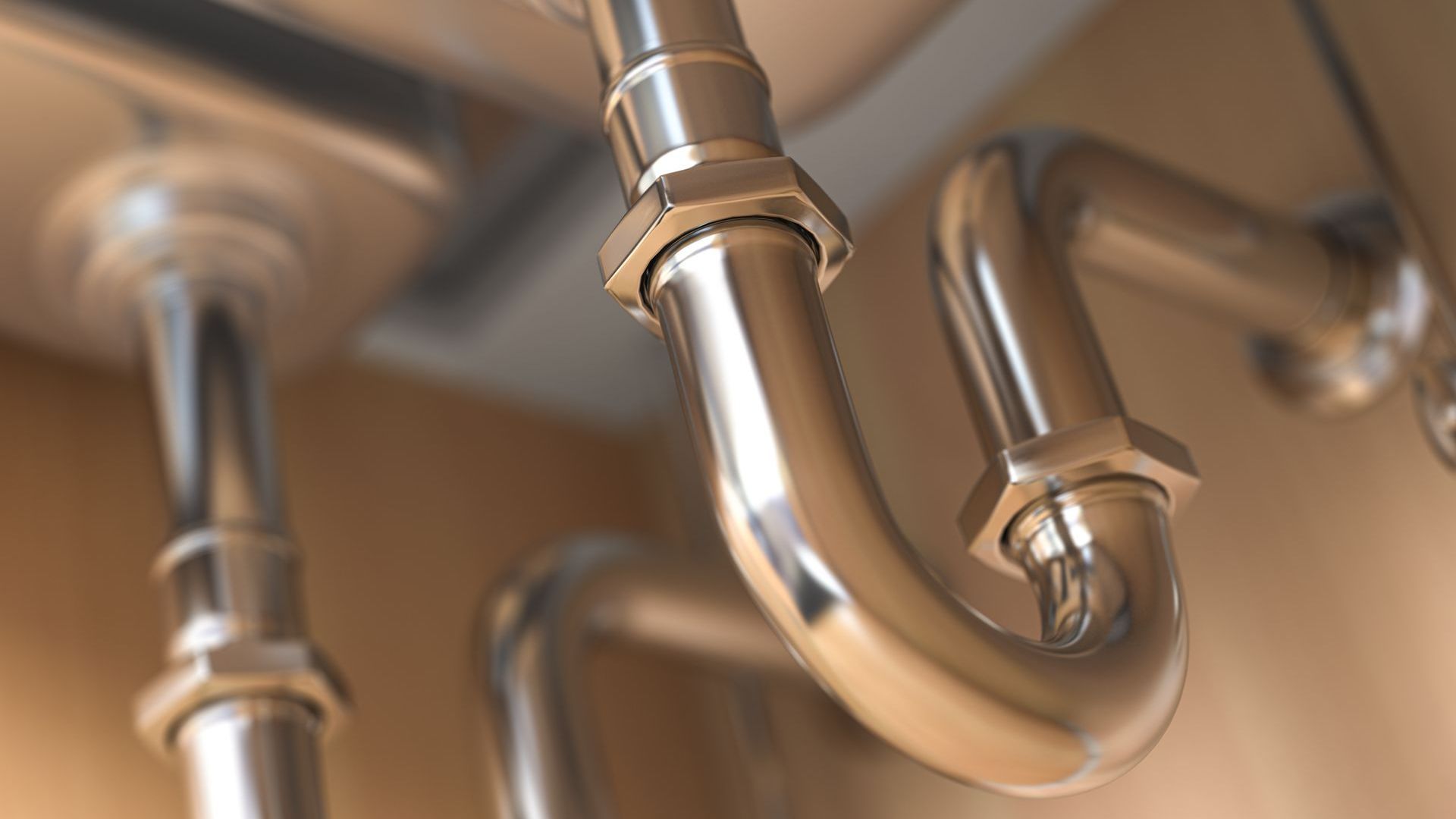 A close up of stainless steel pipes hanging from the ceiling.