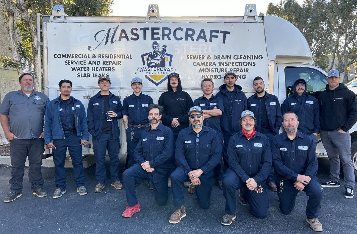 A group of men are posing for a picture in front of a mastercraft truck.