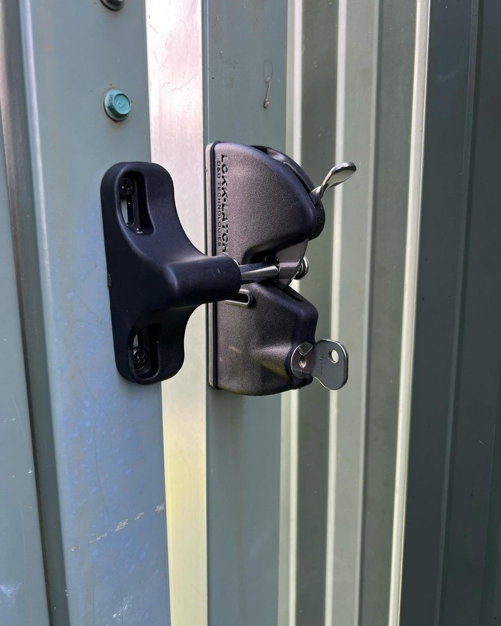 A Close Up of a Gate Lock With a Key Attached to It — JOA - Construction & Maintenance in Appin, NSW