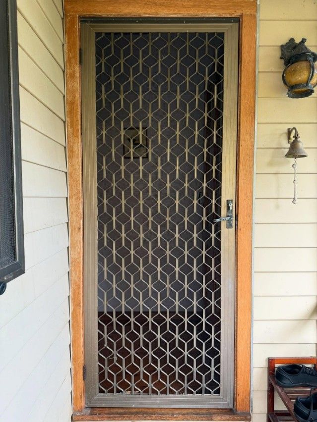 A Door With a Geometric Pattern on It — JOA - Construction & Maintenance in Thirlmere, NSW