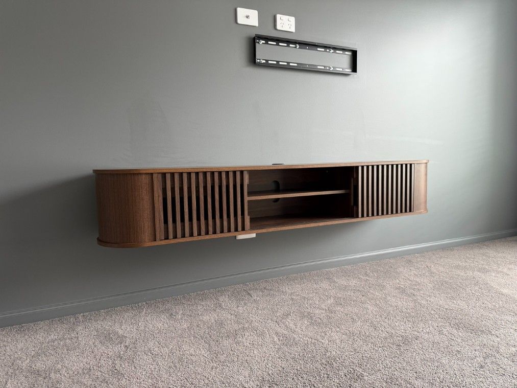 A Wooden Entertainment Center is Hanging on a Wall in a Living Room — JOA - Construction & Maintenance in Appin, NSW
