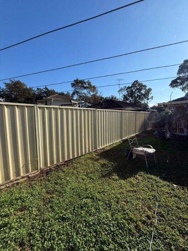 A Yard With a Fence and a Wheelbarrow in It — JOA - Construction & Maintenance in Appin, NSW