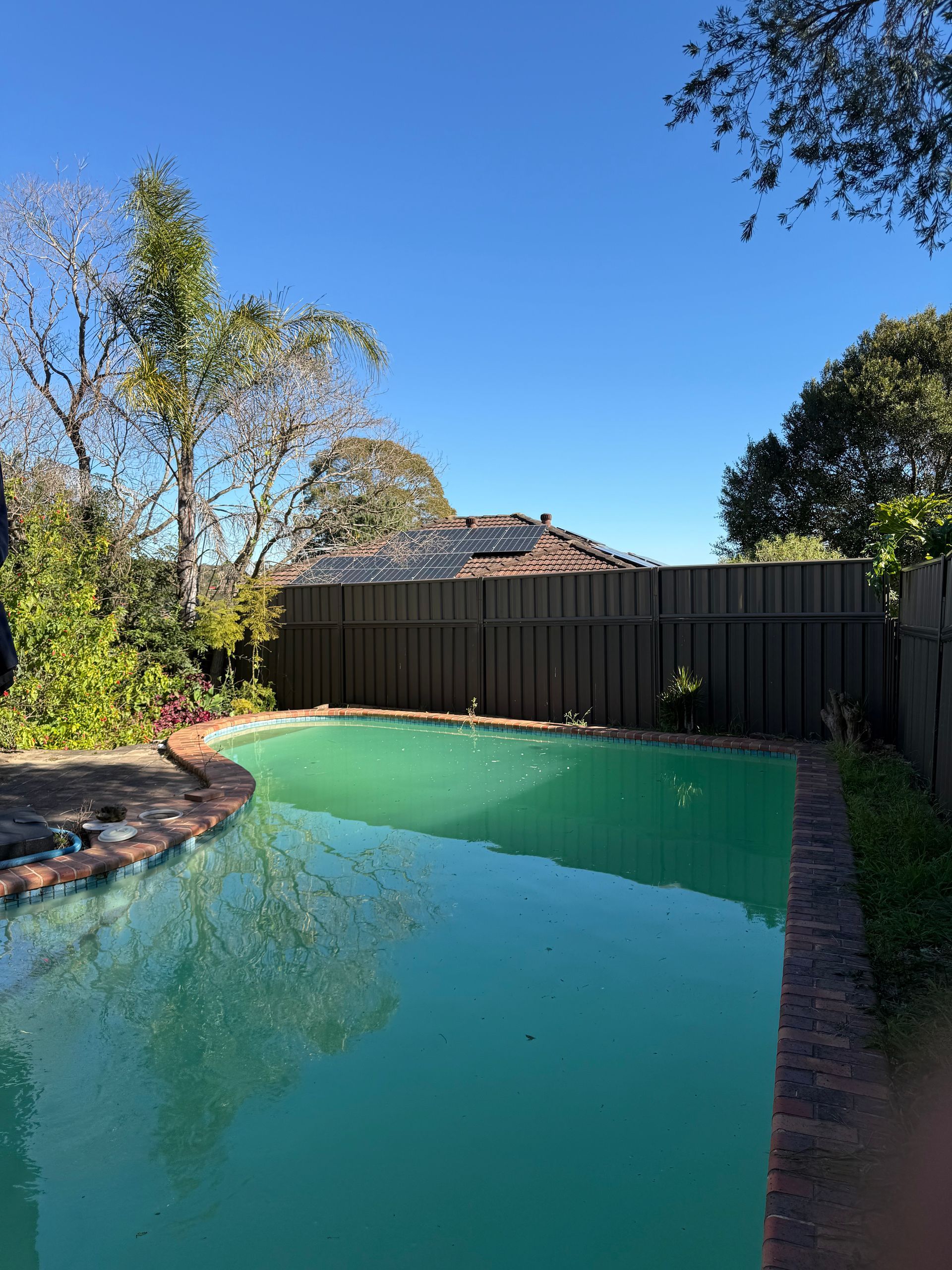 A large swimming pool with a fence around it — JOA - Construction & Maintenance in Appin, NSW