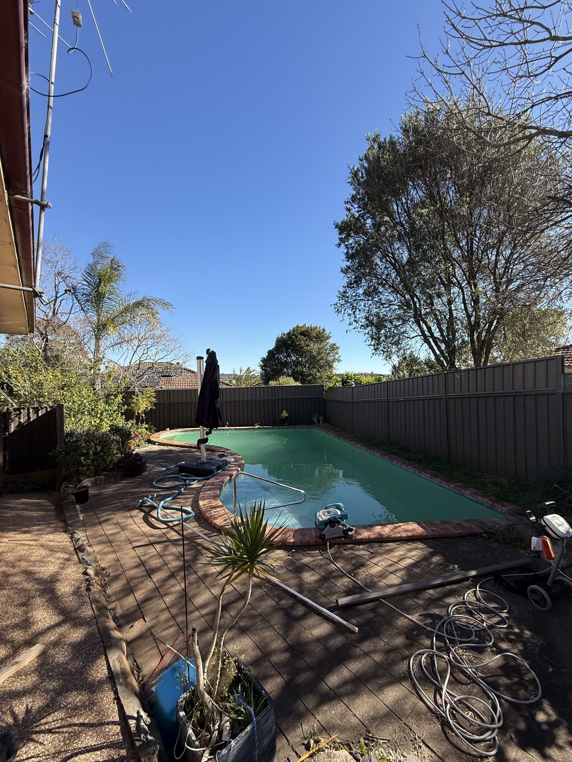 There is a large swimming pool in the backyard of a house. — JOA - Construction & Maintenance in Campbelltown, NSW