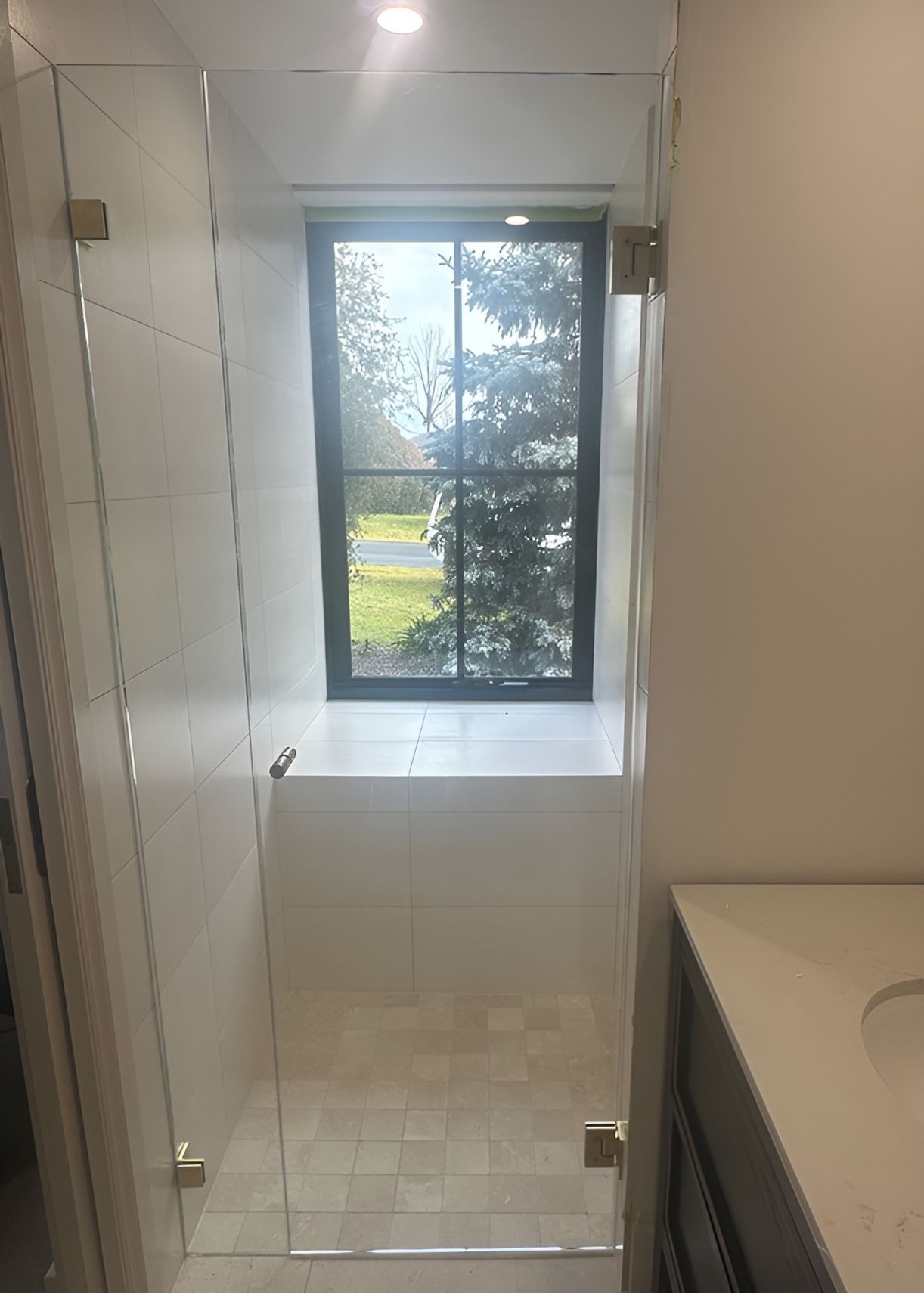 A Bathroom With a Glass Shower Door and a Window — Canobolas Glass Service In Orange, NSW
