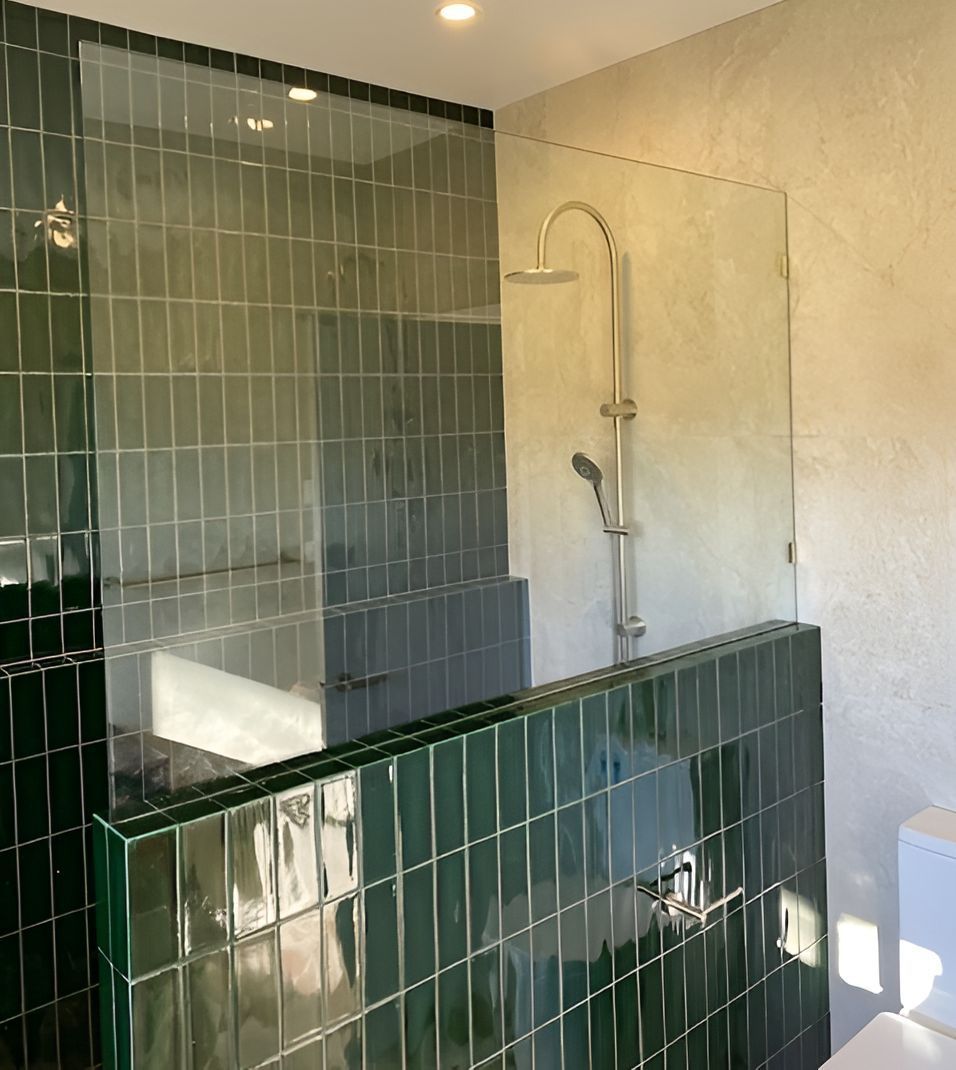 A Bathroom With Green Tiles and a Glass Shower Door — Canobolas Glass Service In Orange, NSW