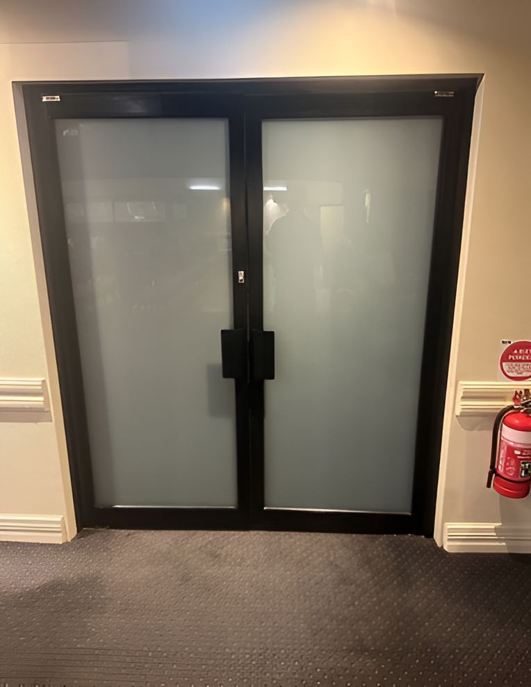 There is a Fire Extinguisher Next to the Door — Canobolas Glass Service In Orange, NSW