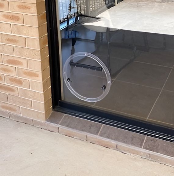 A Sliding Glass Door With a Clear Plastic Circle on It — Canobolas Glass Service In Orange, NSW
