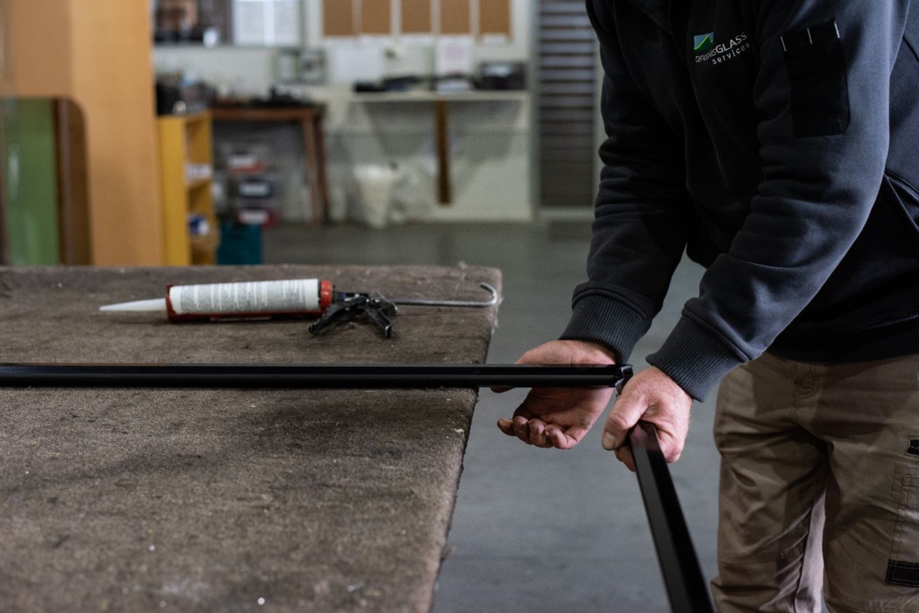 Skilled Craftsman Repairing Glass — Canobolas Glass Service In Orange, NSW
