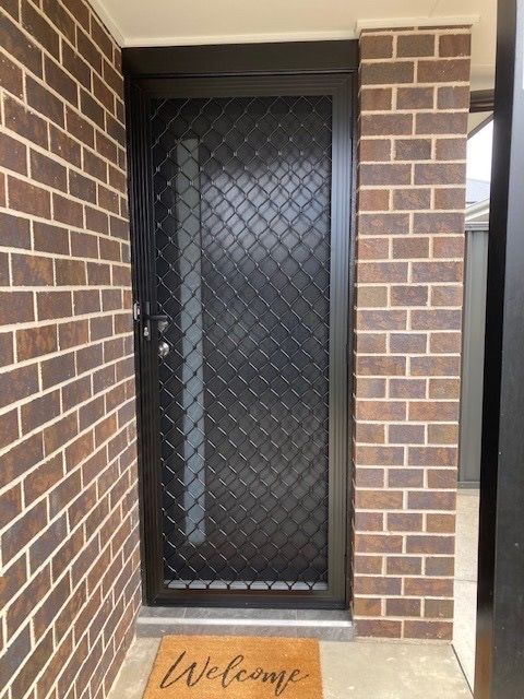 A Black Door With a Welcome Mat in Front of It — Canobolas Glass Service In Orange, NSW