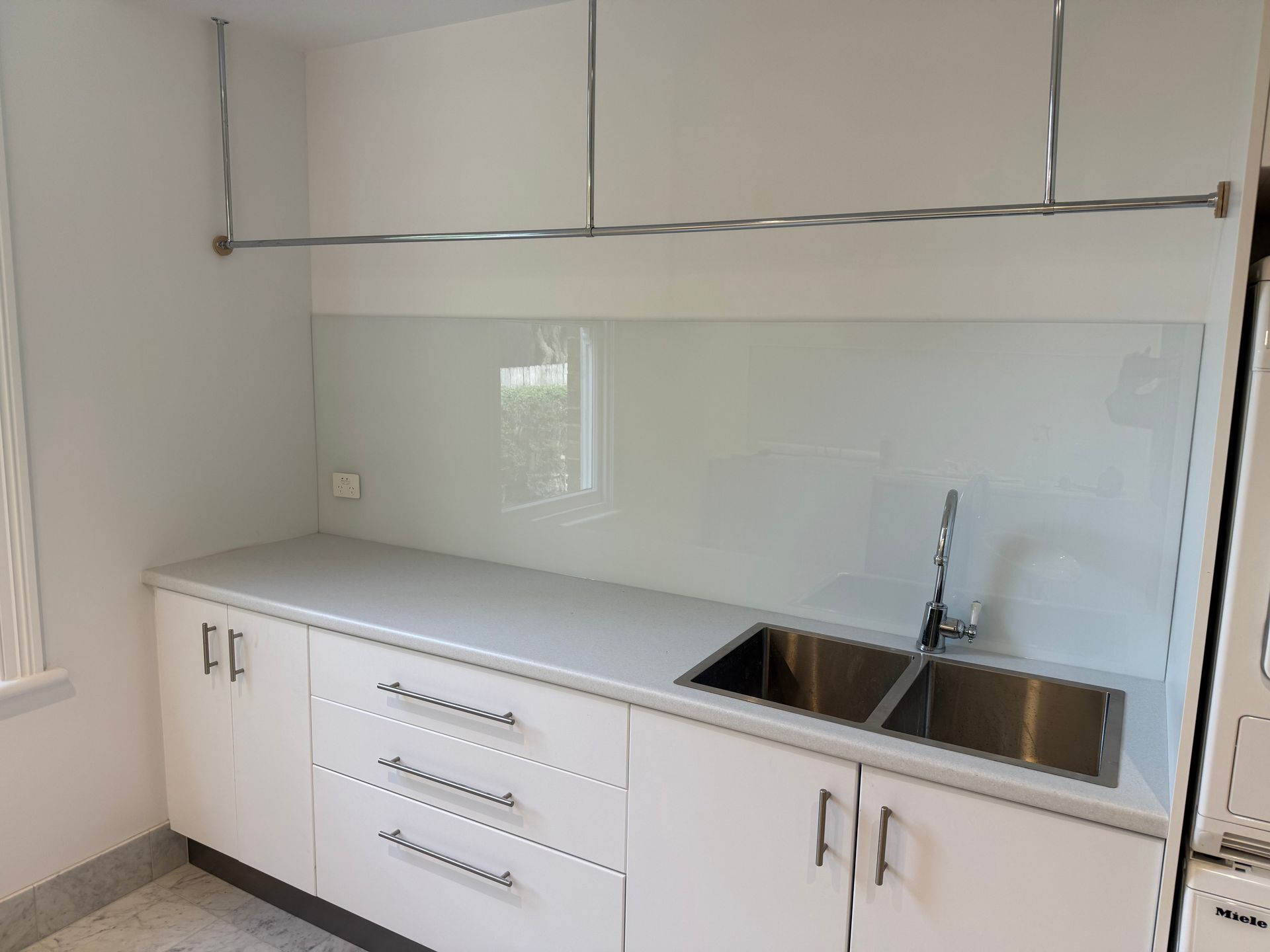 White Kitchen benchtop and sink with a glass wall — Canobolas Glass Service In Orange, NSW